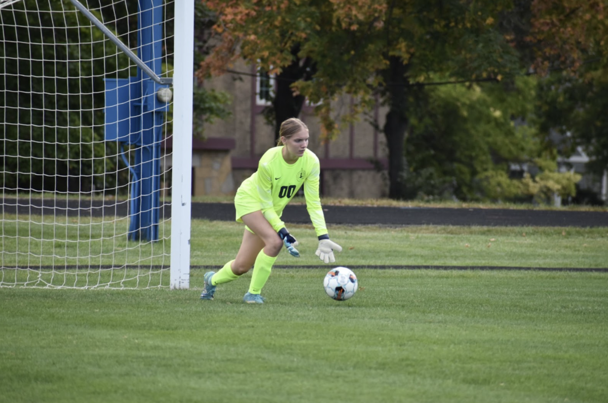 HEAD IN THE GAME. Senior Natalie Waibel saves a shot from a teammate during warm ups.
